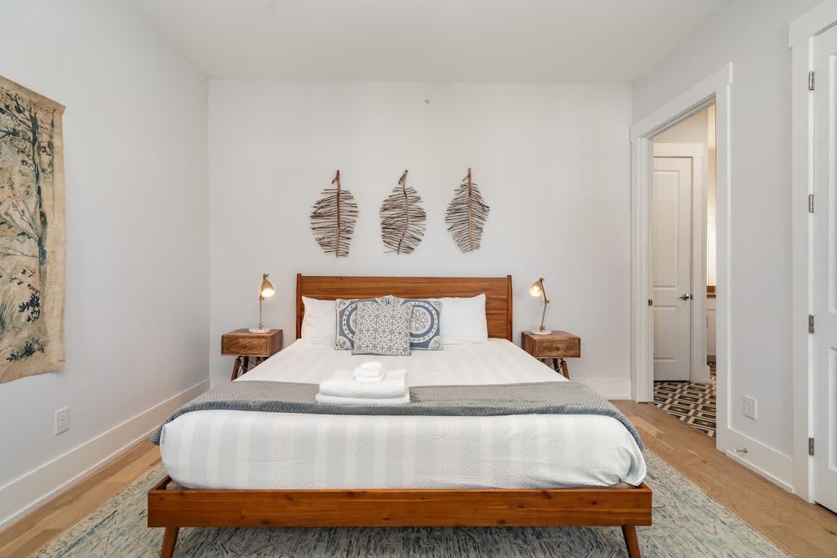 2nd bedroom with a King bed, smart TV, closet space, and en-suite jack-n-jill bathroom.