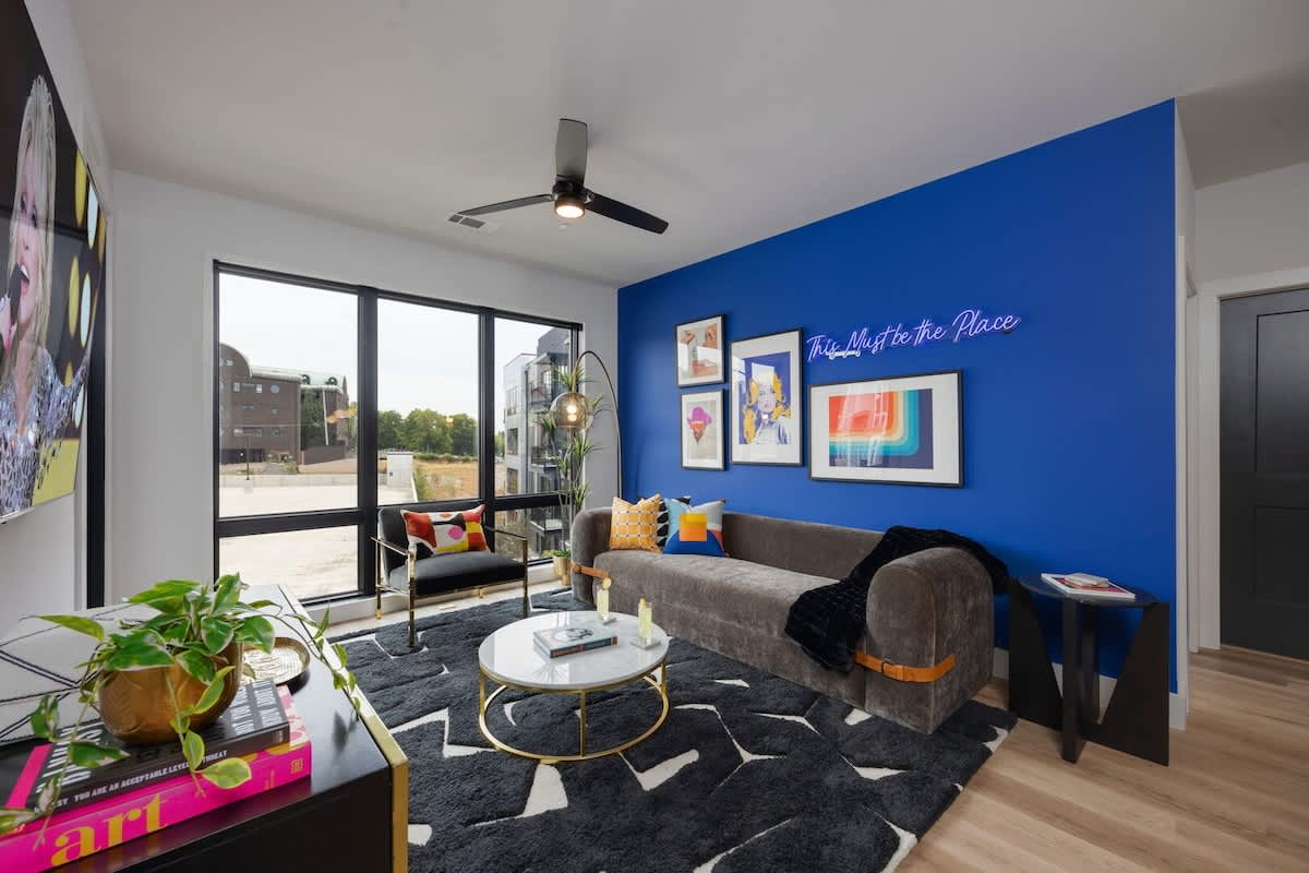 Open concept living area with floor to ceiling windows! Features designer furniture and smart TV!