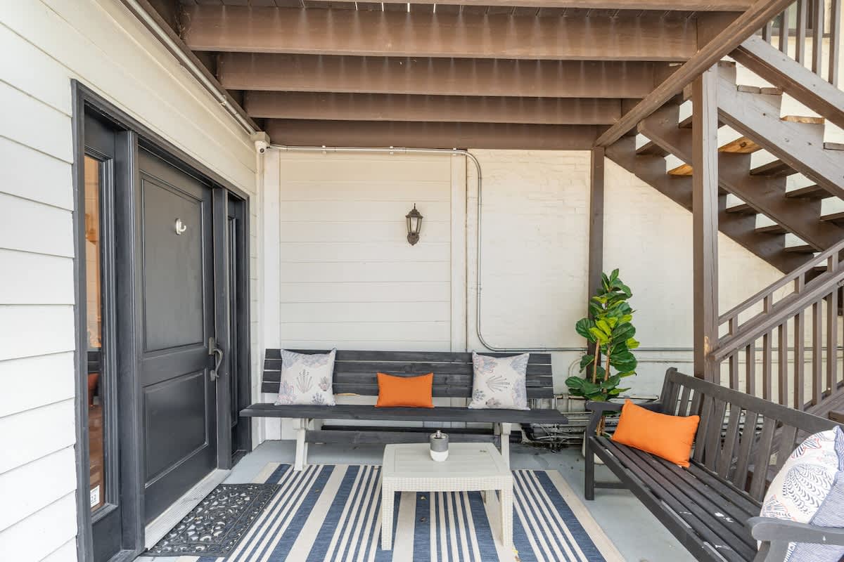 Patio area with outdoor seating next to the private parking lot.