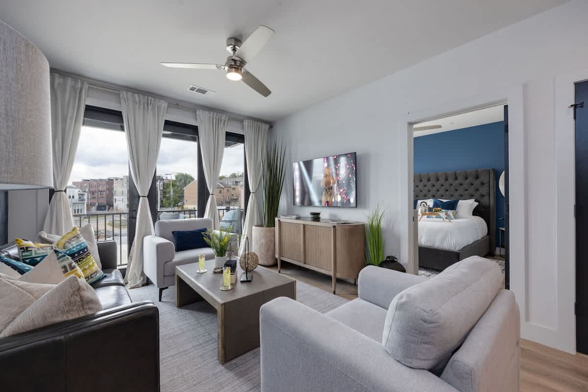 Unit 4: Bright open living space featuring SMART flat-screen TV, and designer furnishings throughout.
