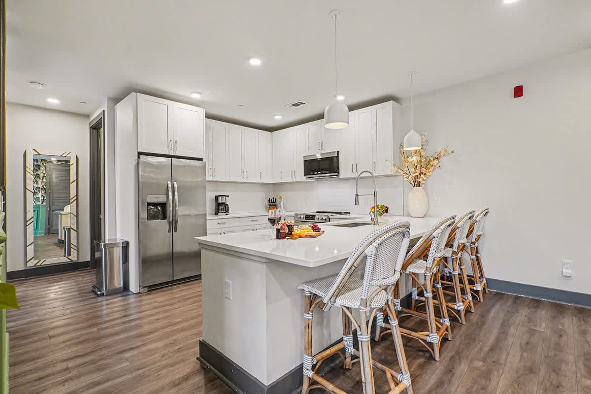 Fully equipped kitchen with stainless steel appliances and ample counter space with bar seating for 4 guests.