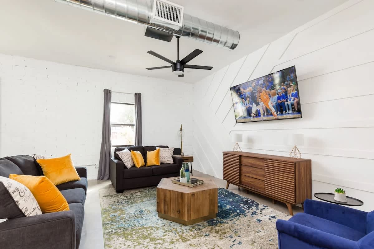 Unit 2: Relax in style with this spacious open-concept living room, featuring a cozy atmosphere and a smart TV for endless entertainment.
