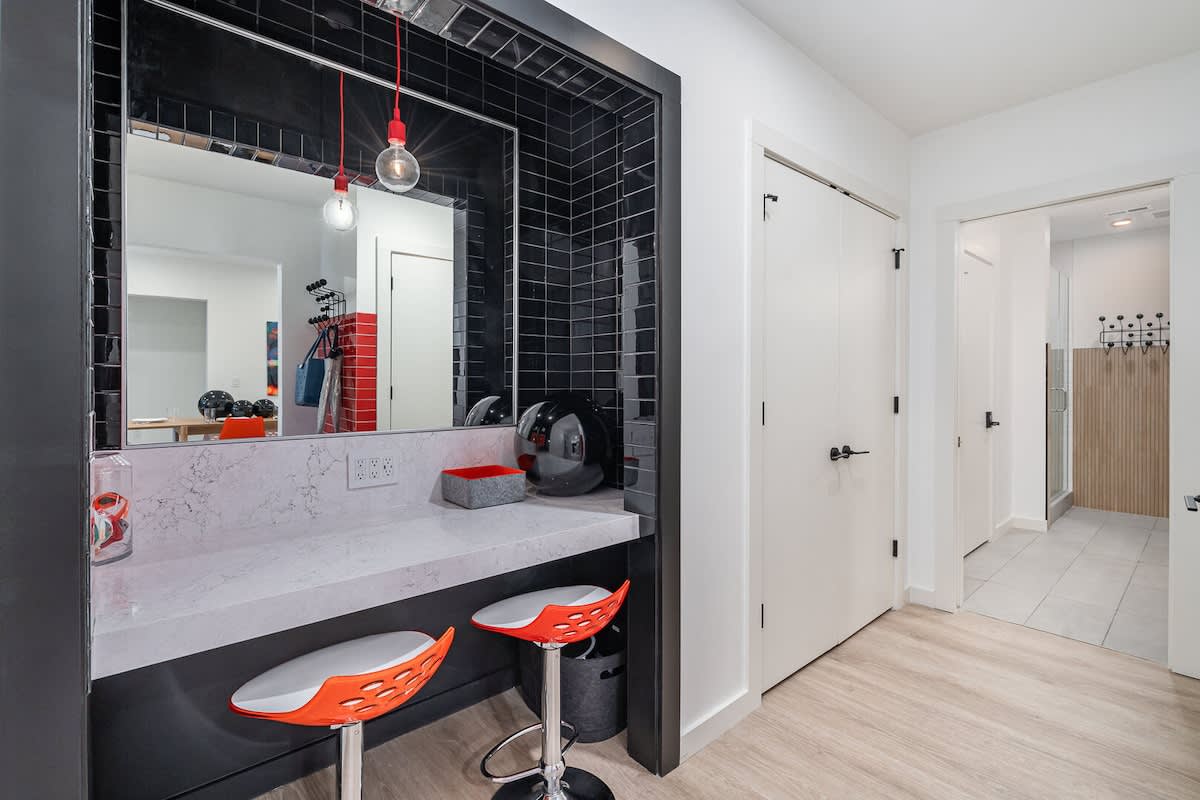 Primary bathroom with built-in vanity and closet space.