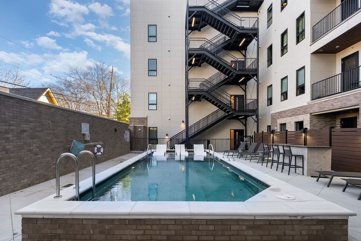 Communal Area: A tranquil pool area with sun loungers, perfect for guests to relax and soak up the sun.