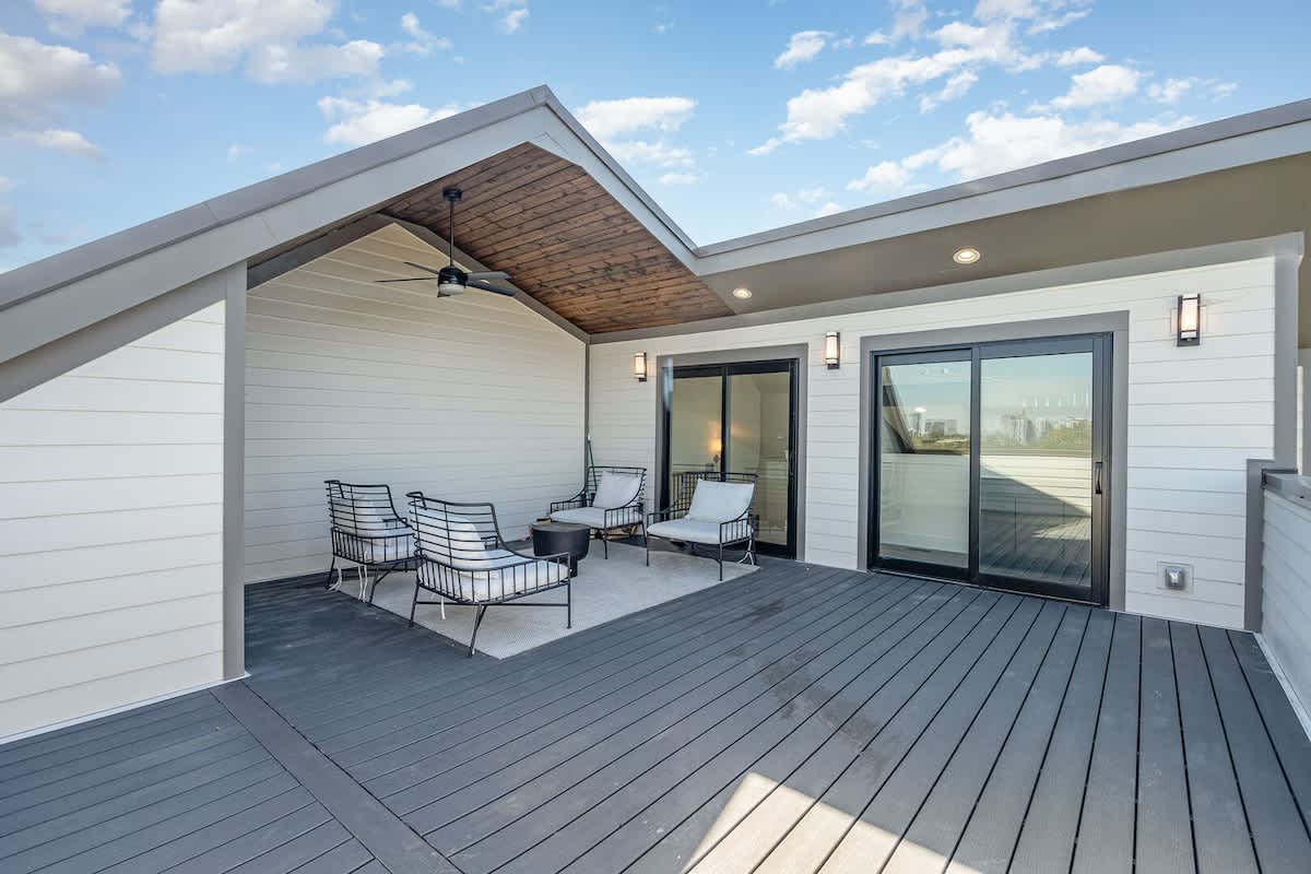 Private partially covered rooftop deck offering stunning city-skyline views and outdoor furnishings for lounging. (4th Floor)