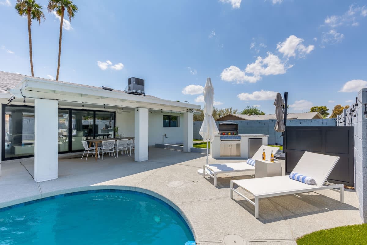 Private backyard with pool, built in grill, putting green and lounge areas