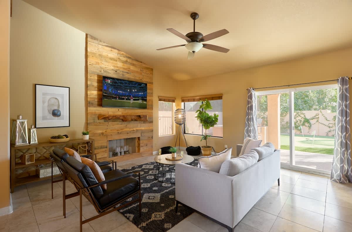 Bright open living space featuring a smart TV, designer furnishings, and access to the backyard.