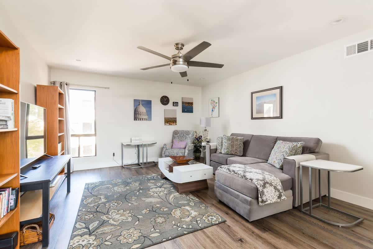 Modern open floor plan featuring a designer furnished living room with a flat-screen SMART TV