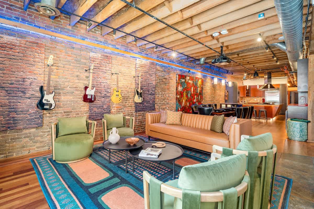 Main Living Area featuring designer furnishings, TV Projector, piano, electric guitars, and electronic Window Curtains