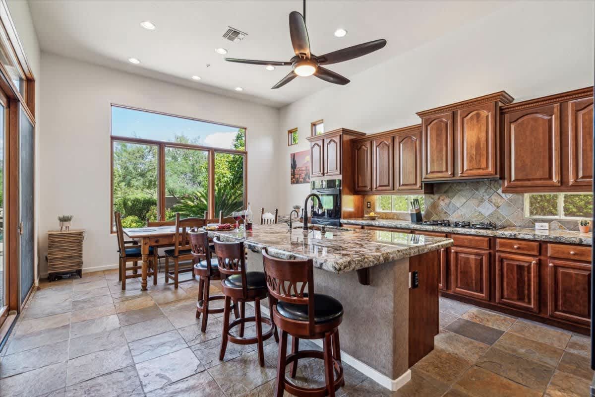 Stunning and fully equipped kitchen with speckled granite countertops and modern appliances.