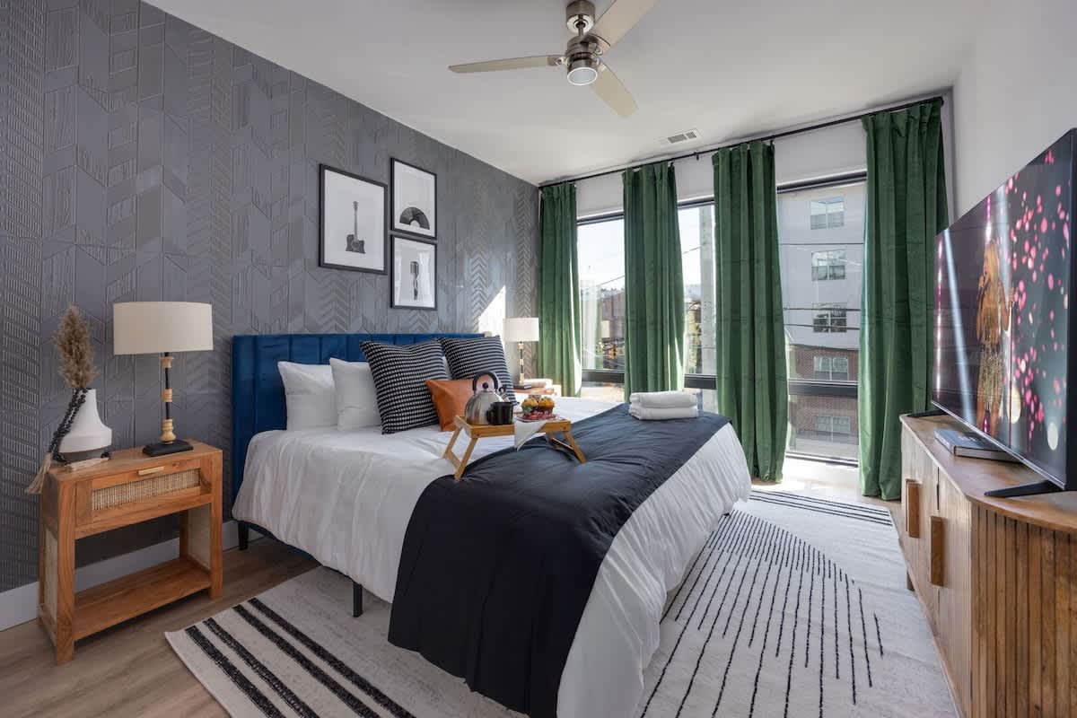 Unit 3: Primary bedroom with King bed, smart TV, large walk-in closet, and ensuite jack-and-jill bathroom with shower/tub combo.