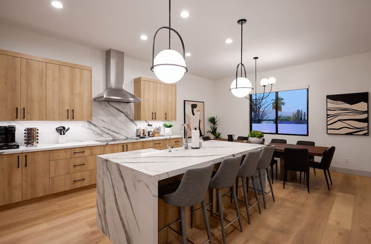 Bright open floor living space, designer furnishings, smart TV, and large sliding doors leading to the private outdoor oasis. (1st Floor)