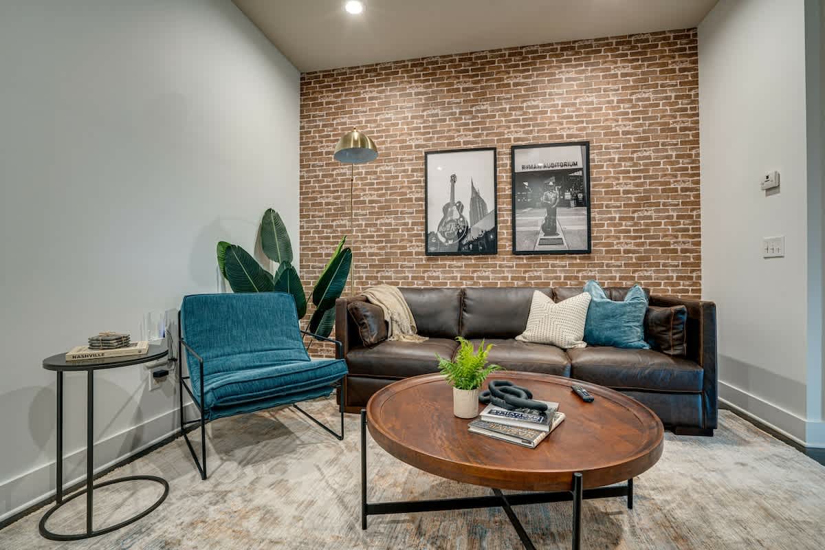 Urban style living room with designer furnishings and flat screen TV.