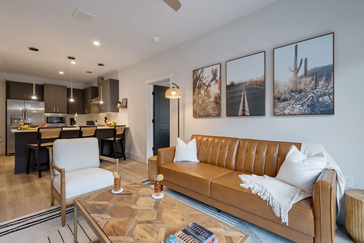 2nd Unit: Bright living room with comfortable seating, smart TV, designer decor, and access to the outdoor patio.