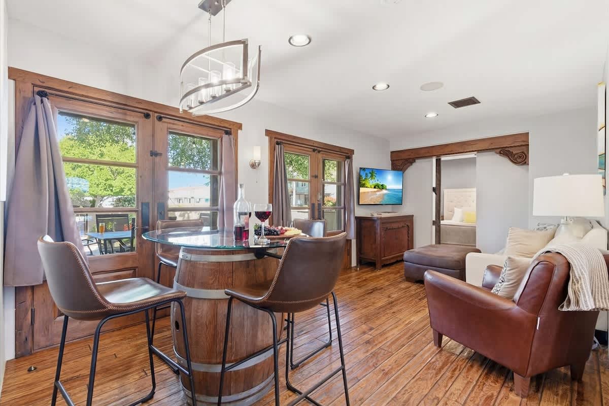 Bright and open living area featuring cozy furnishings, a Smart TV, dining area for 4 guests, and access to the front yard.