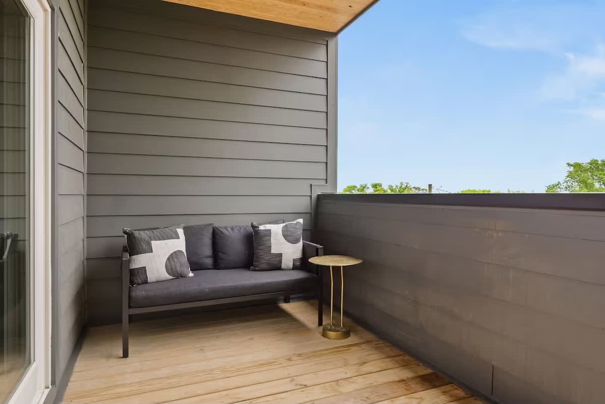 Private balcony with covered seating and a dining area, perfect for morning coffee, evening drinks, or relaxing in the fresh air. (3rd Floor)