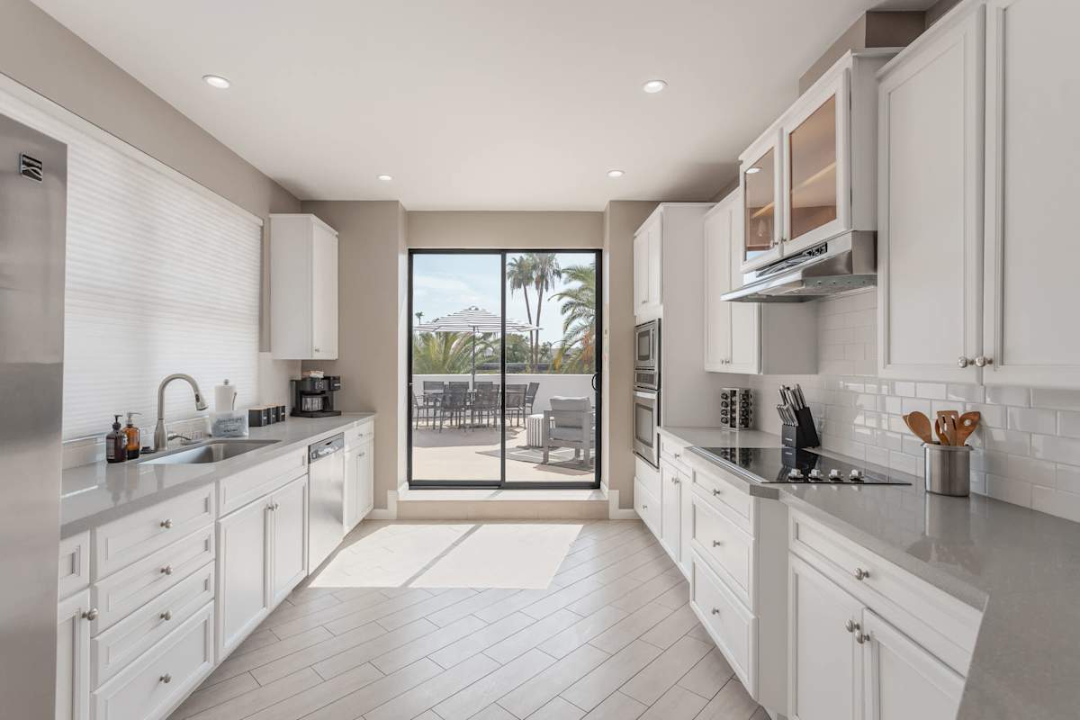 Modern kitchen featuring stainless steel appliances, generous counter space, and a breakfast bar perfect for casual dining and morning coffee.