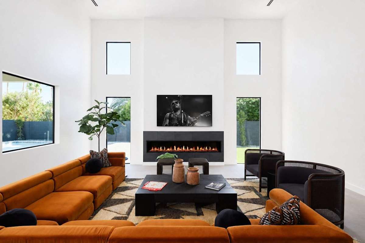 Professionally and intricately designed modern styled living area with large hand-painted mural, 20 ft vaulted ceilings, large electric fireplace, large smart TV, and complete with designer furnishing