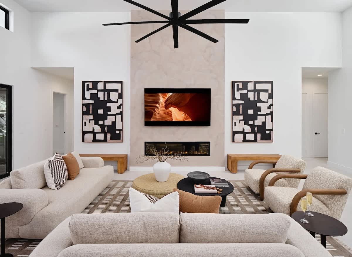 Unit 1: Grand open-concept living space with designer decor, featuring a fireplace and Smart TV.