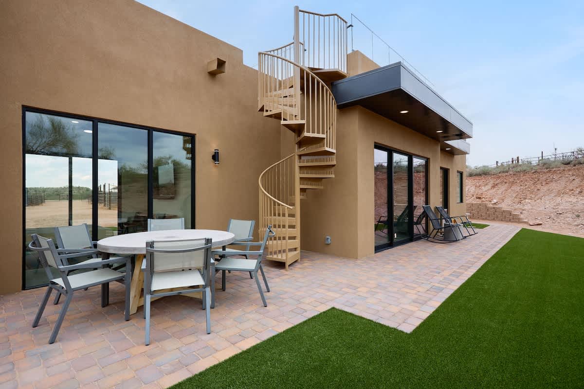 Stunning private oasis with private patio, outdoor dining table, mini fridge, and outdoor seating.
