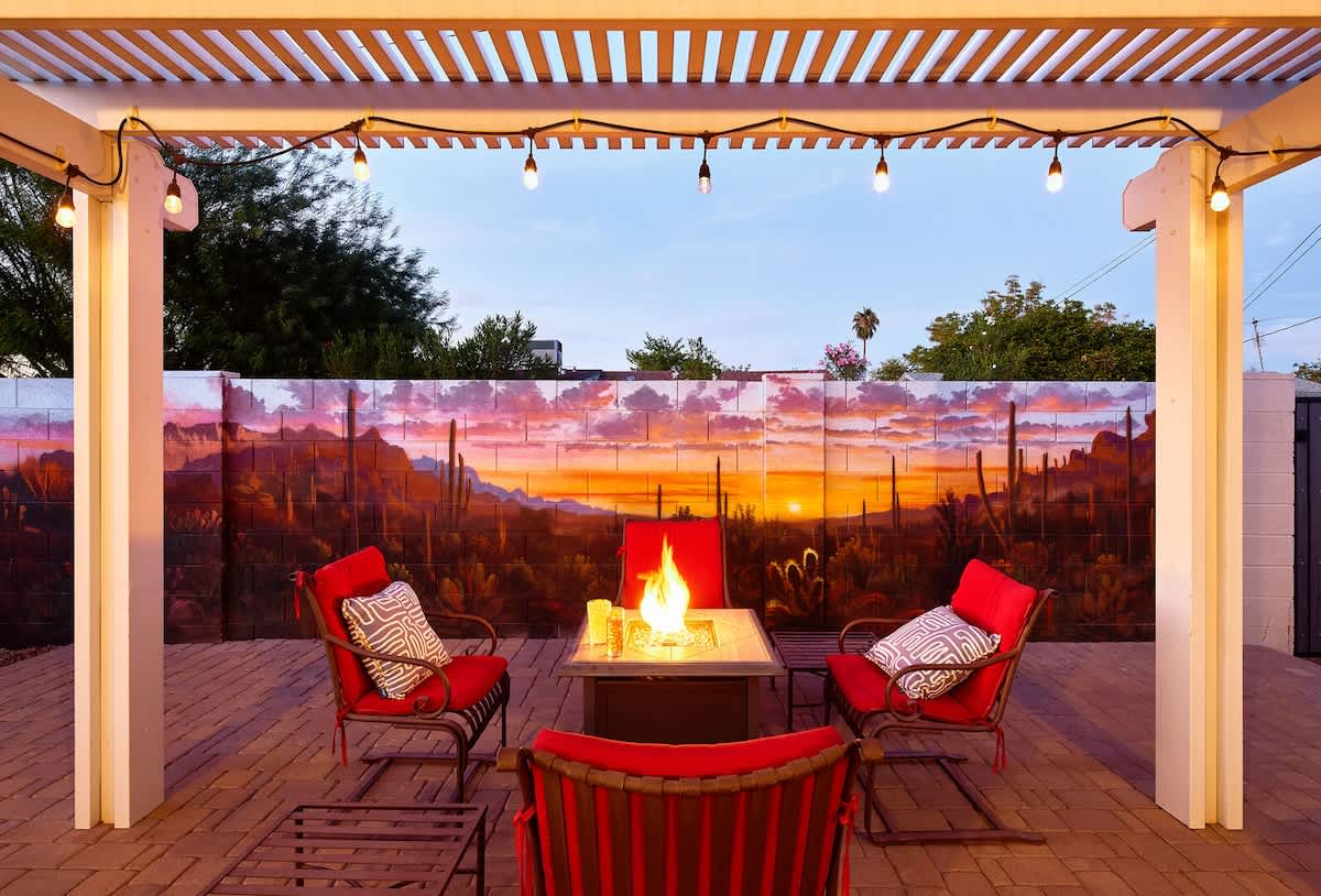 Private backyard patio with a new mural, outdoor dining area, ample seating, hot tub, above-ground pool, lounge chairs, fire pit, BBQ grill, ping pong table, and horseshoe.