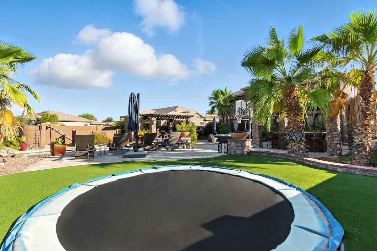 Outdoor in-ground trampoline and basketball hoop.