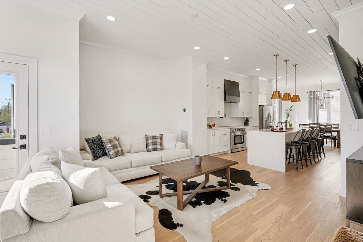 2nd Floor: Bright and open living area with cozy furnishings, a smart TV, and a private balcony.
