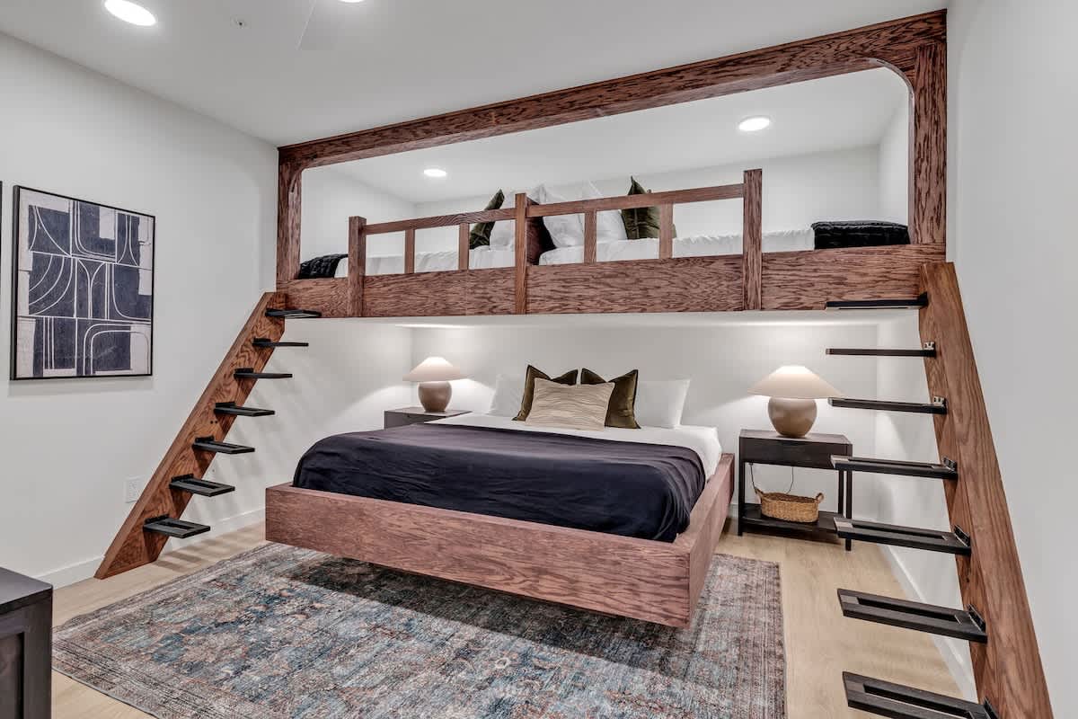 2nd bedroom with 2 Full beds (loft style) over a King bed, smart TV, and designer furnishings.