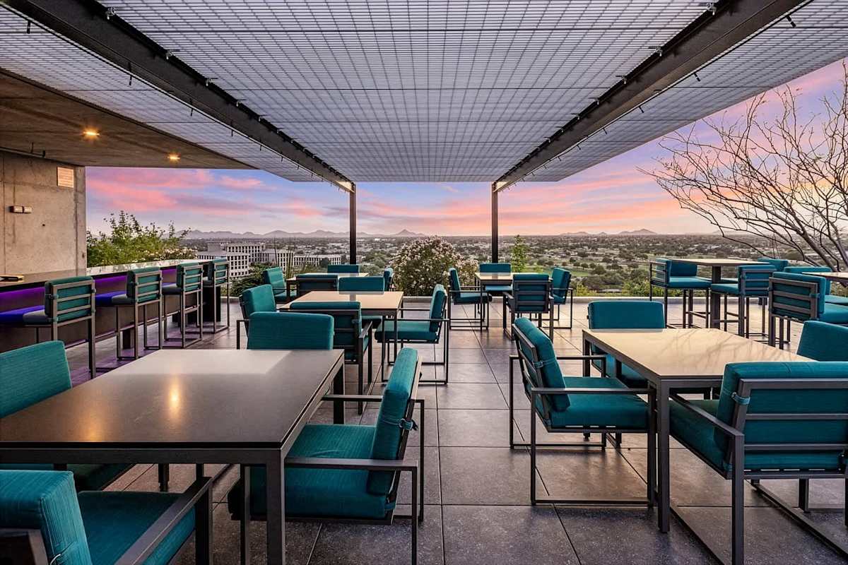 Communal Area: Rooftop area with a sparkling pool, hot tub, cabanas, sun loungers, outdoor kitchen with bar seating, BBQ grills, and outdoor dining areas.