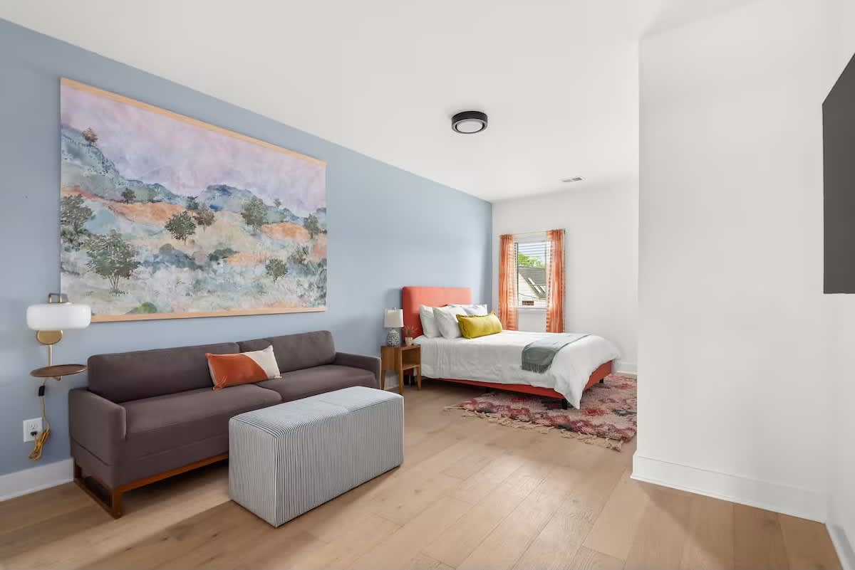 Versatile primary bedroom with a cozy bed, a queen sleeper sofa for extra guests, a Smart TV, and plenty of space to unwind. (3rd Floor)