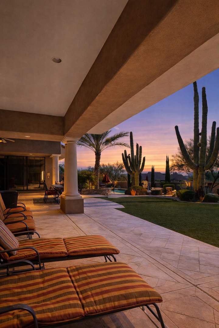 Extended covered patio offering additional sun loungers and patio furnishings.
