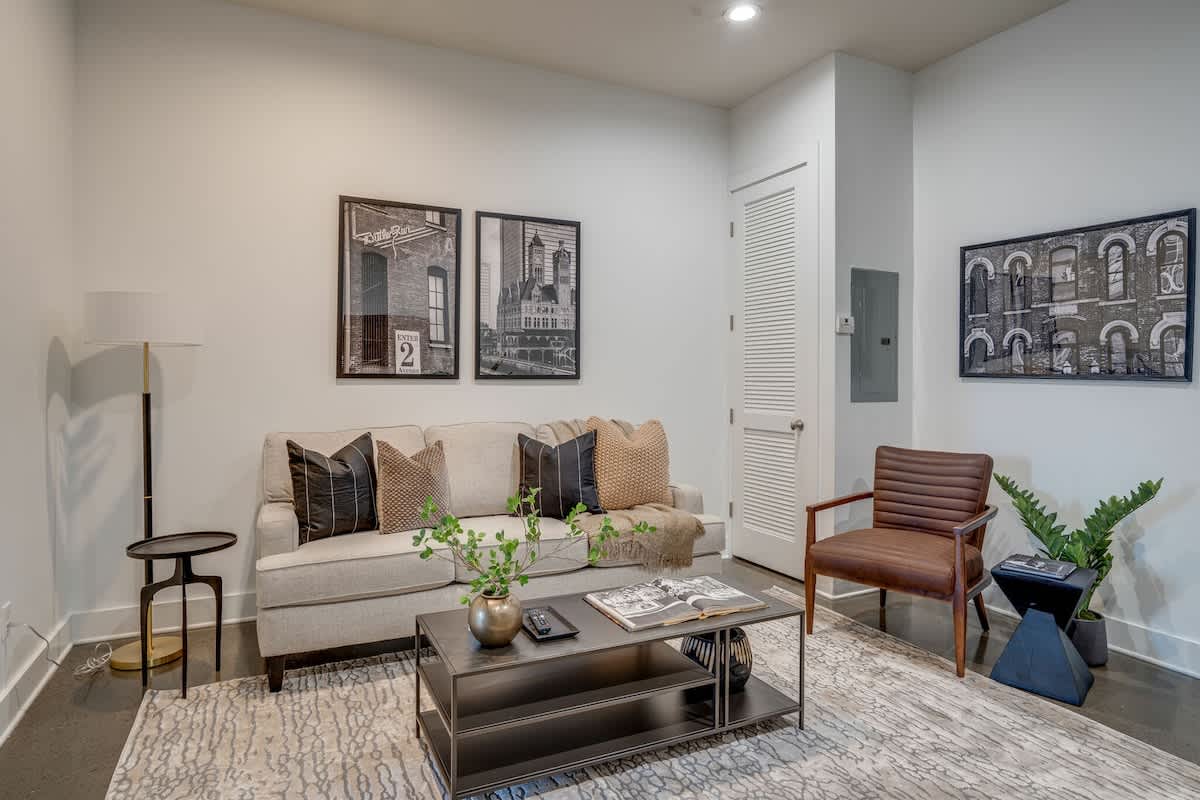 Open concept living area with designer furnishings and smart TV.