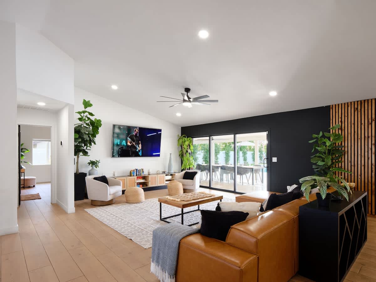 Open living area featuring plush furnishings, a Smart TV, and access to the backyard.