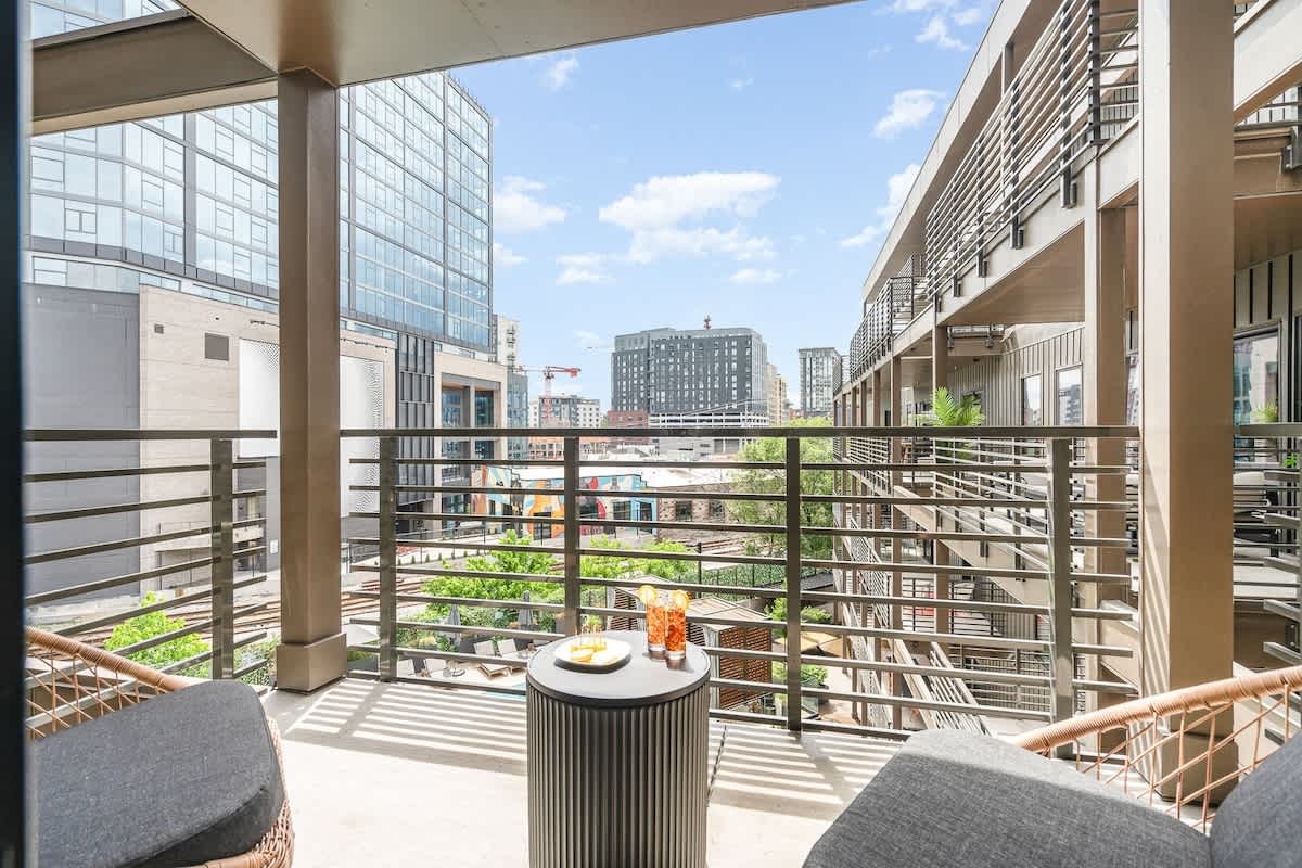 Private patio off the living room and primary bedroom offering a gorgeous view of the pool and Music City!