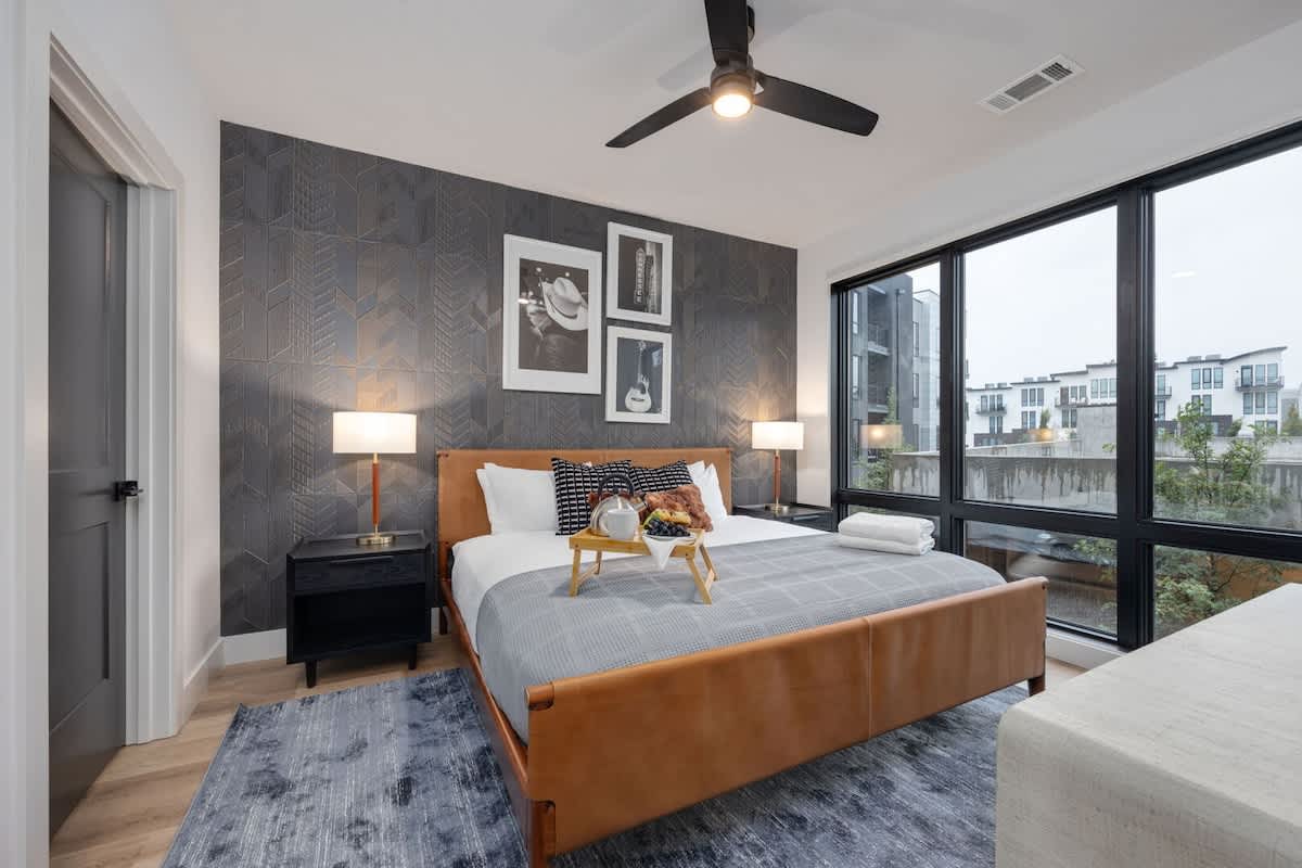 Unit 1: Primary Bedroom with King bed, smart TV, large walk-in closet, and en-suite bathroom.