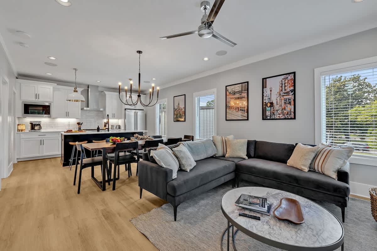 Unit 1 - 2nd Floor: Cozy and welcoming open-concept living area effortlessly integrates the stylishly furnished living room with the fully equipped kitchen and dining space.