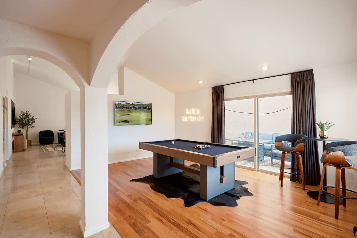 Game room featuring a pool table, smart TV, small dining nook, and access to the backyard.