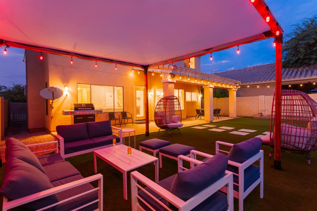 Outdoor canopy with lounge area, heated optional sparkling pool, fire pit, and additional lounging areas.