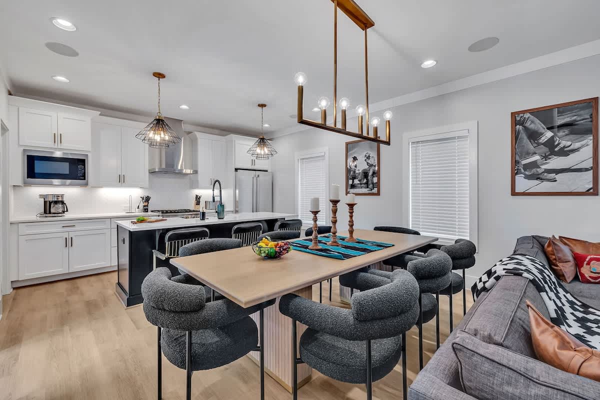 Unit 2 - 2nd Floor: Formal dining table between the living room and kitchen offering a large table to accommodate 8 guests.