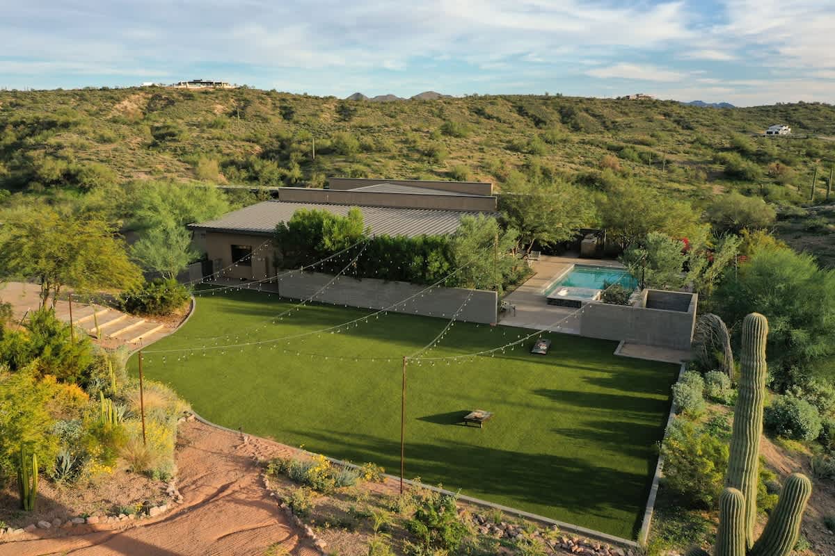 Estate 1 - Stunning private oasis featuring a sparkling blue pool and spa with sun loungers, a patio with a BBQ grill, outdoor furnishings for lounging and dining, and a fire pit surrounded by unparal