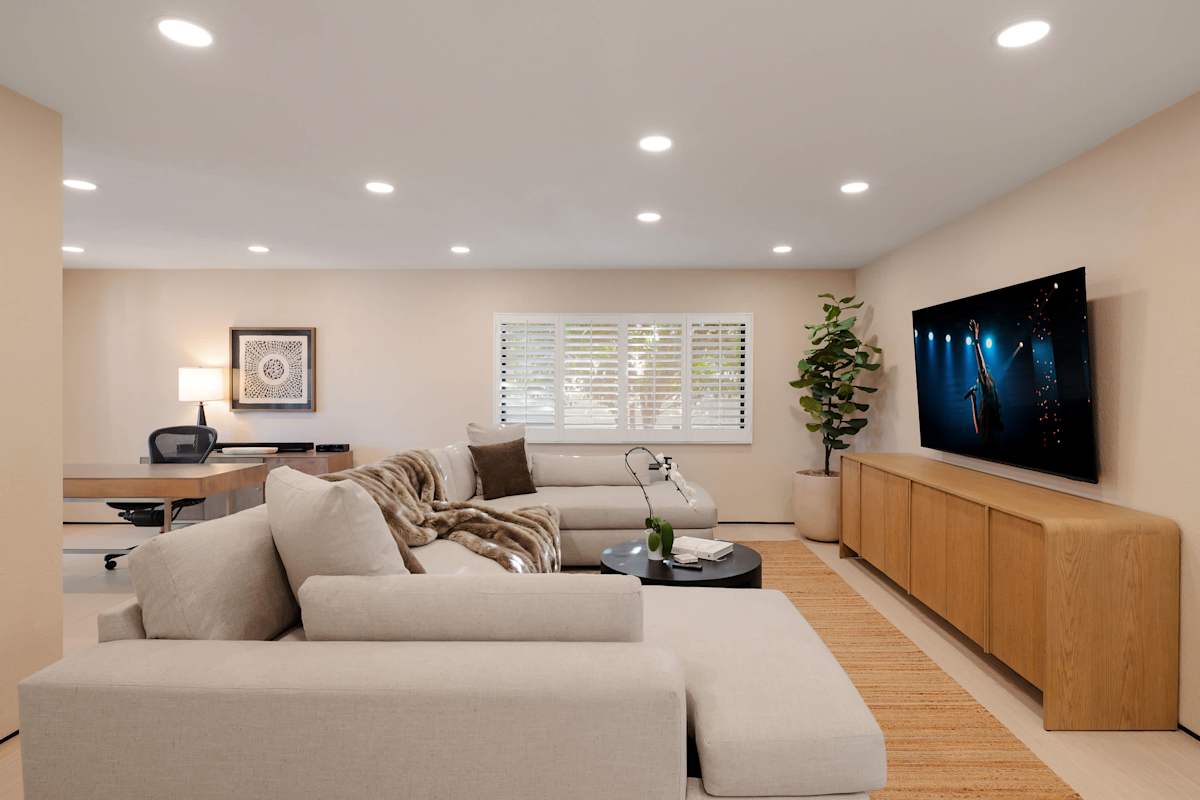 Inviting living room with plush lounge seating, a large Smart TV, and a warm, modern design, creating the perfect place to unwind after a day of exploring Scottsdale.