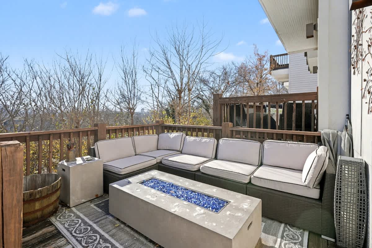 1st Floor: Private patio with outdoor seating surrounding a fire pit, a smart TV and a BBQ grill.