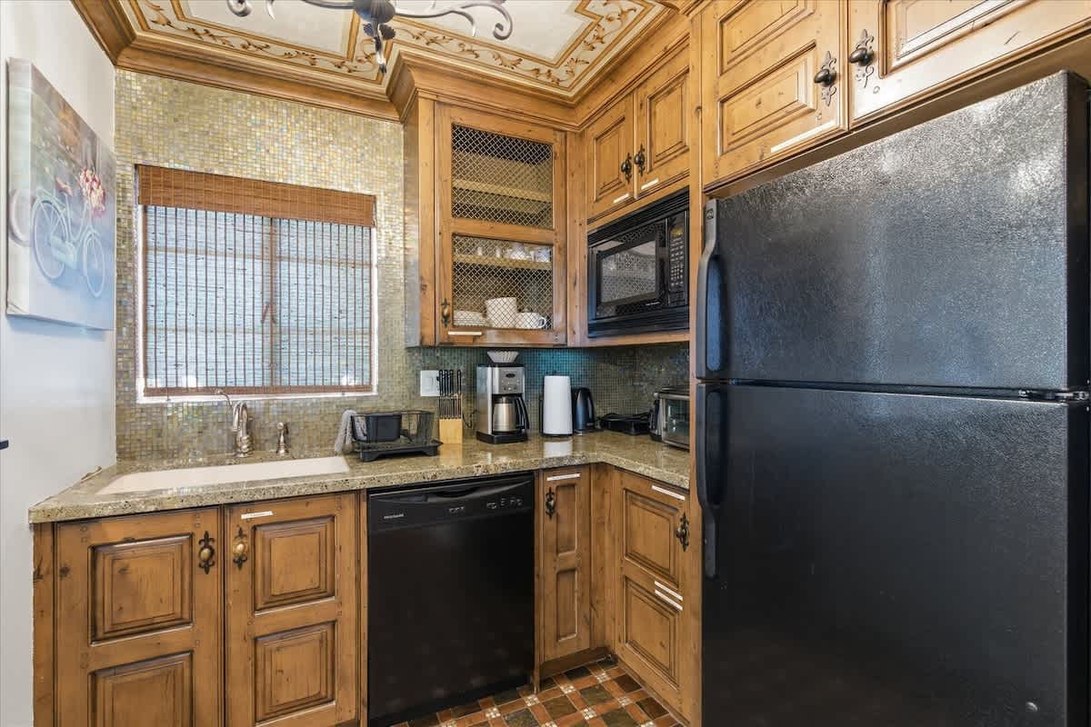 Unit 1: Inviting kitchen with modern appliances and bar seating for 2 guests.