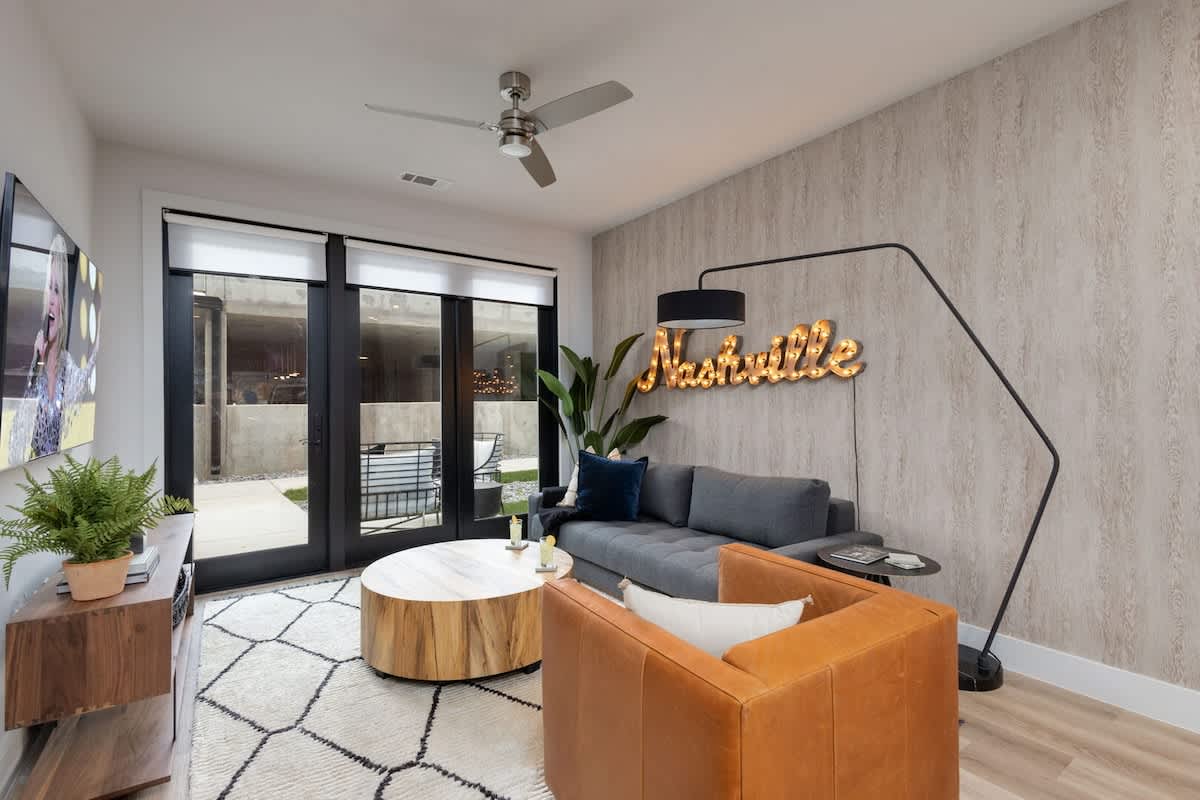 1st Unit: Bright living room with comfortable seating, smart TV, designer decor, and access to the private patio.