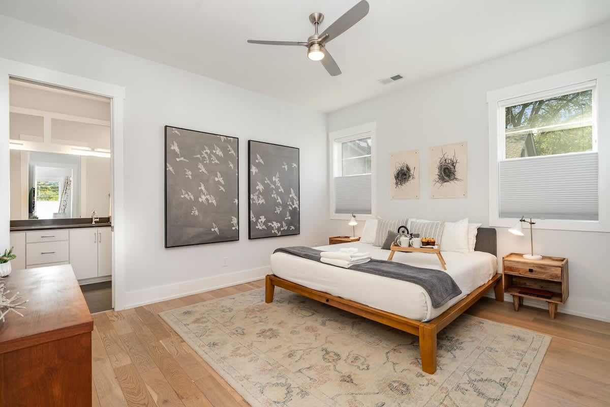 Primary bedroom with a King bed, smart TV,a and en-suite bathroom with a large walk-in closet.