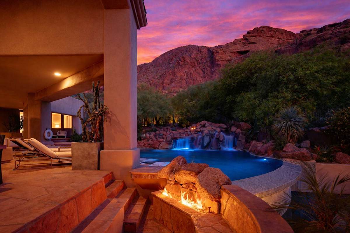 Resort-style backyard with a sparkling pool, waterslide, hot tub, sun loungers, private patio a beautiful view of the scenery.