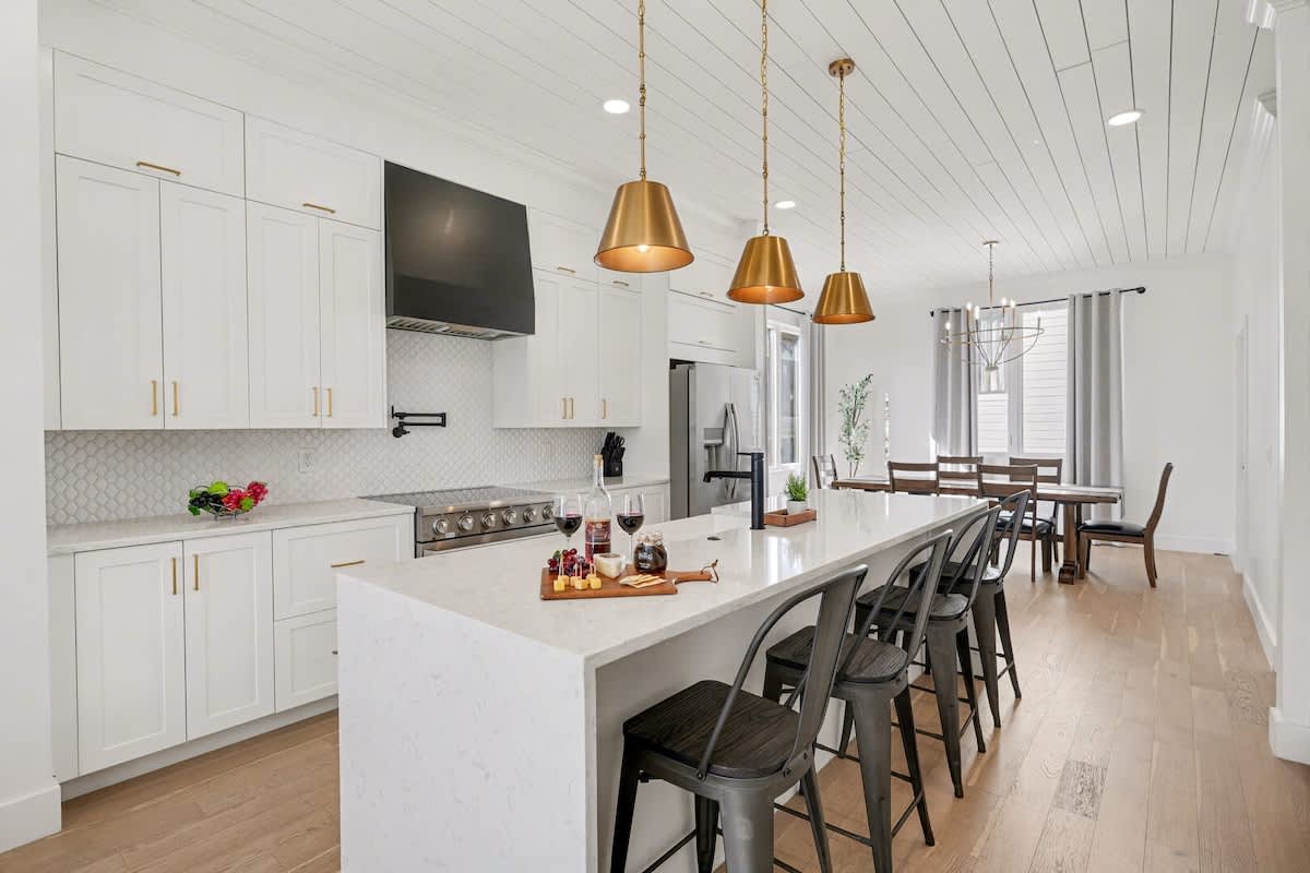2nd Floor: Fully equipped kitchen with stainless steel appliances, a kitchen island with seating for 4 guests, wine cooler, and amble counter space.