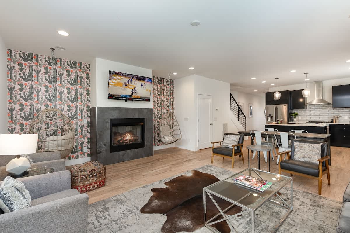Unit 3: Open-concept living area with cozy furnishings, a Smart TV, and a fireplace.