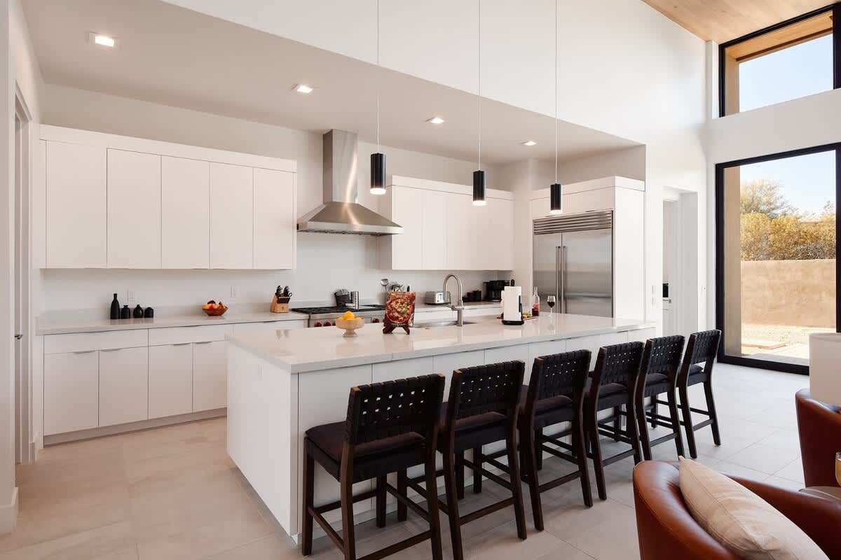 Fully equipped kitchen with stainless steal appliances and a large kitchen island with bar seating for 6 guests.