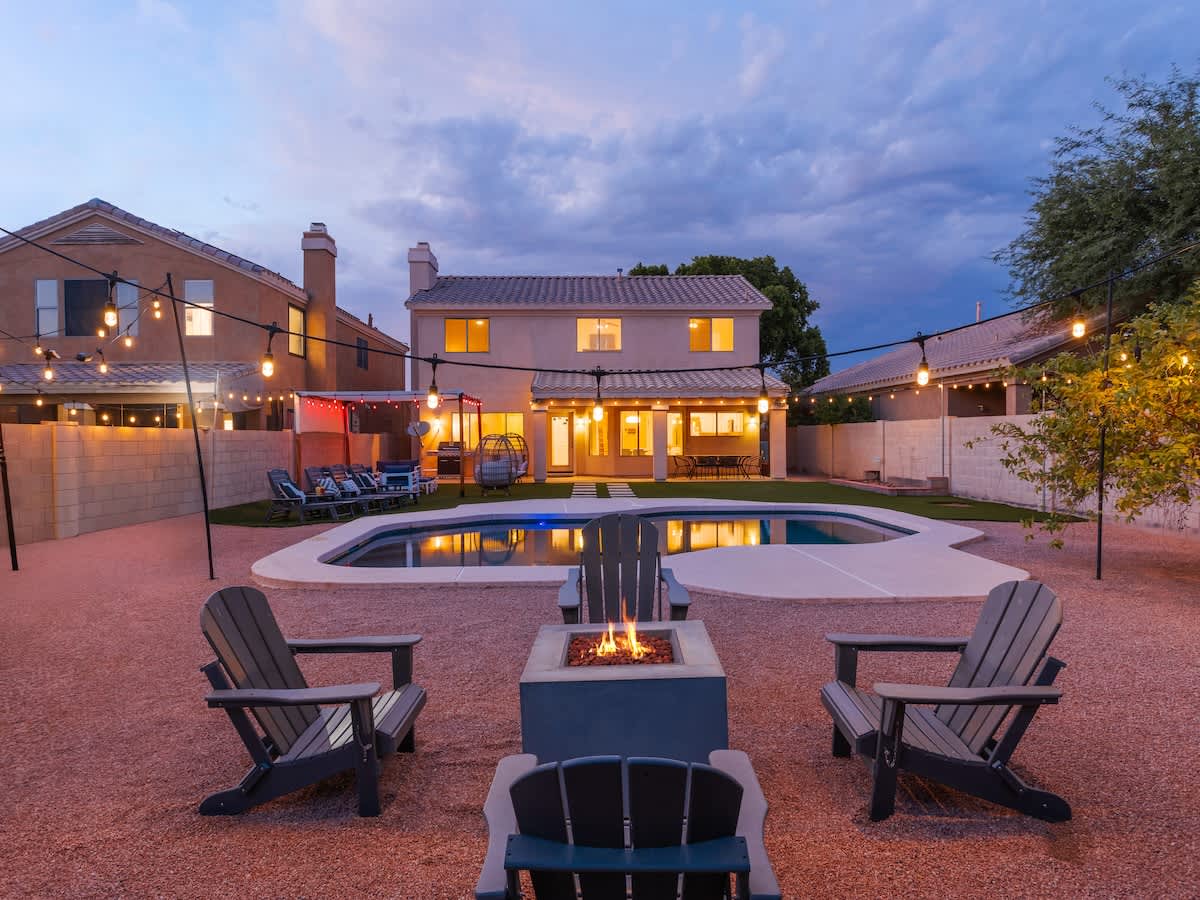 Outdoor canopy with lounge area, heated optional sparkling pool, fire pit, and additional lounging areas.